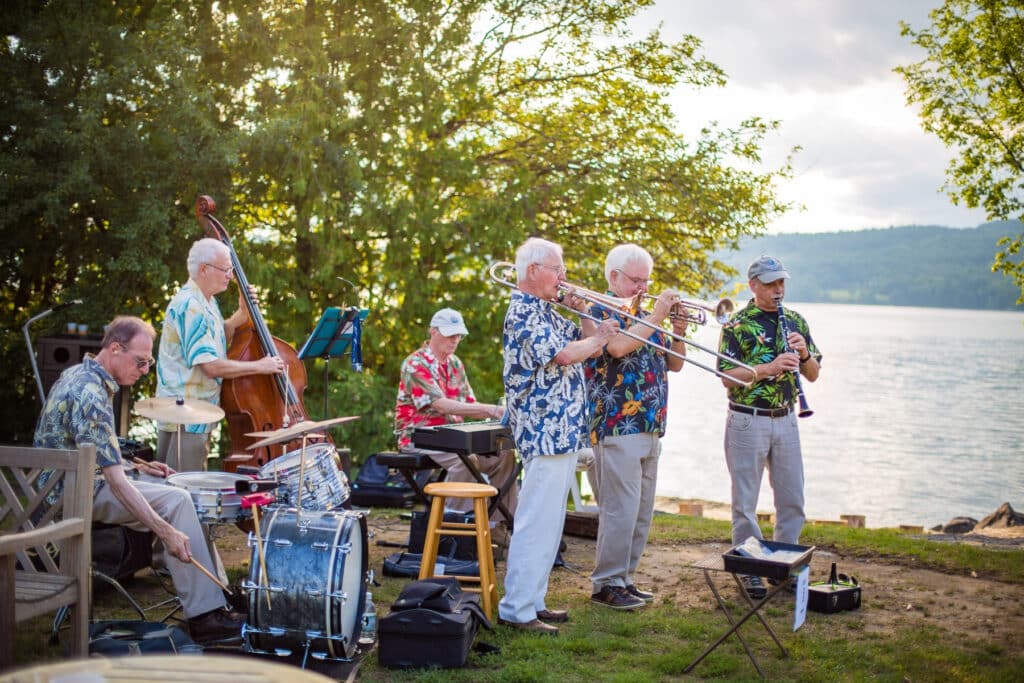 Group of musicians playing outside at the north dock for Shore Dinner