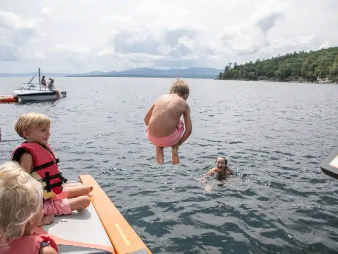 A kid jumping into the lake