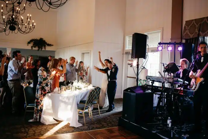 A couple entering their wedding reception