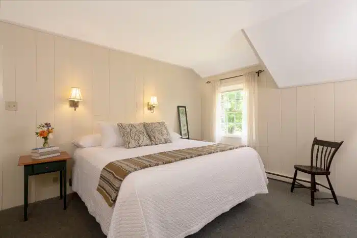 A bedroom with a queen bed in one of the accommodations