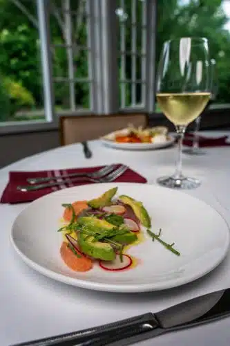 Fine dining in Ardelia's restaurant at Basin Harbor. Colorufl plate with grapefruit, avocado and radish.