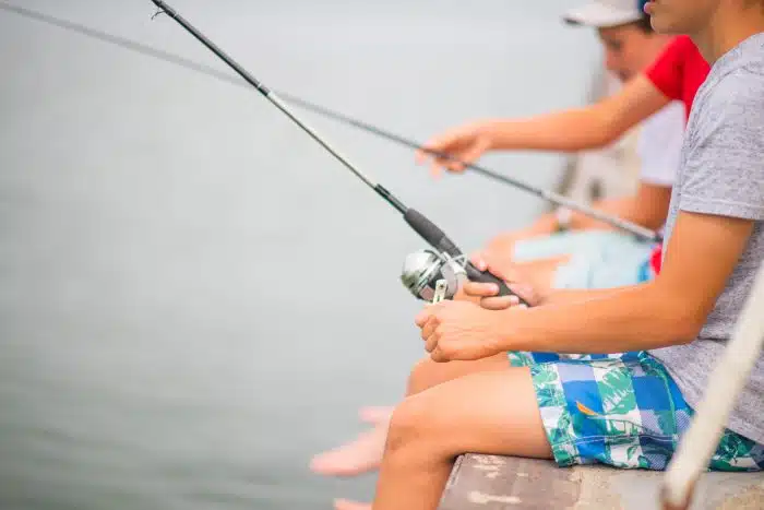 A group of kids fishing at the dock