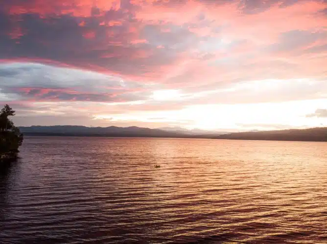 A person kayaking at sunset