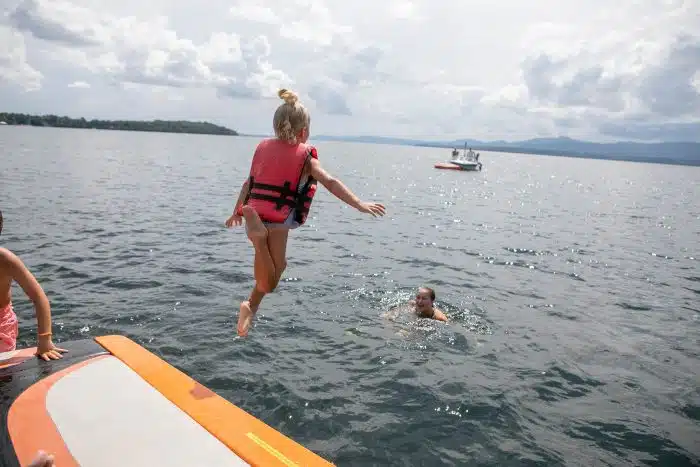 A girl jumping into the lake
