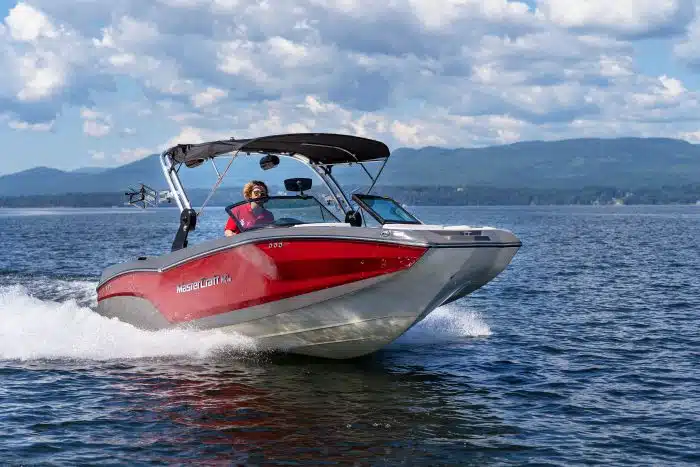 A waterfront crew member driving one of the boats