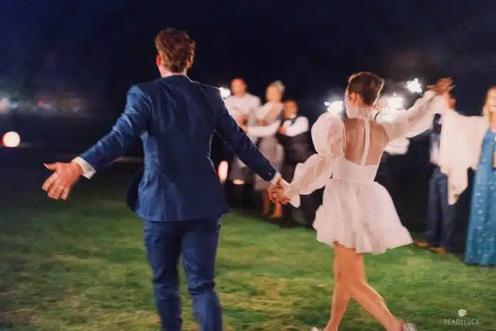A bride and groom leaving their wedding reception
