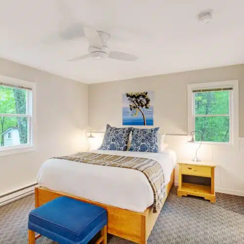 A bedroom with a queen bed in one of the accommodations