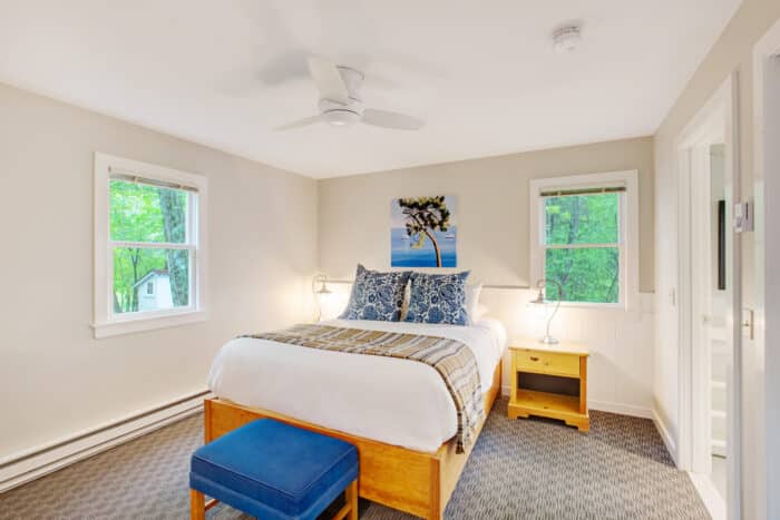 A bedroom with a queen bed in one of the accommodations