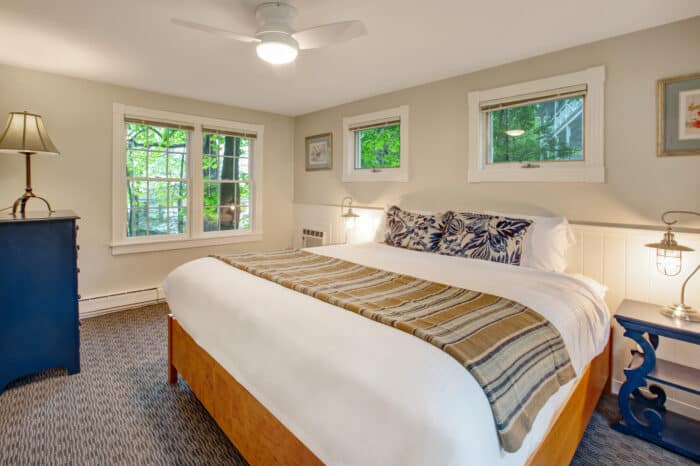 A bedroom with a king bed in one of the accommodations