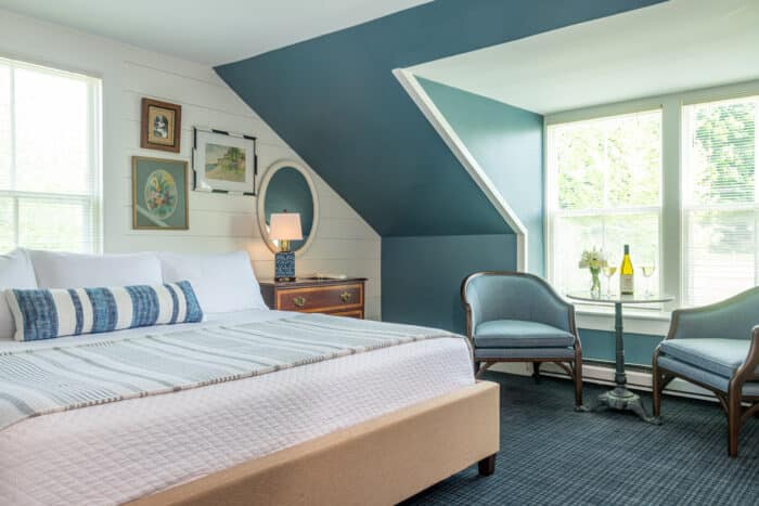 A bedroom with a king bed in one of the accommodations