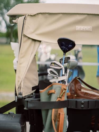 Close up on clubs in the back of a golf cart
