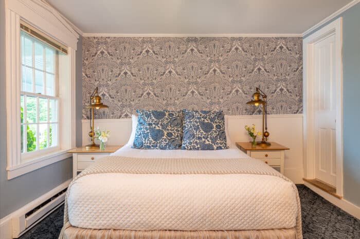 A bedroom with a queen bed in one of the accommodations