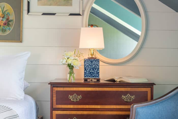 A bedside table in one of the accommodations