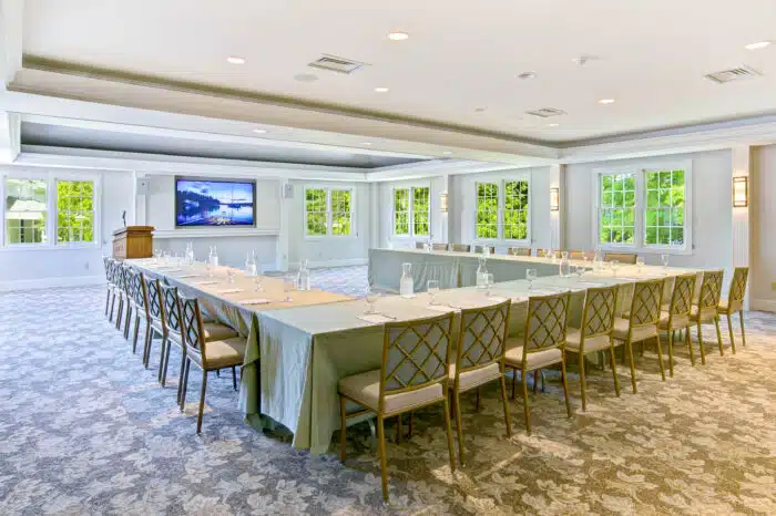 Horseshoe meeting table set up with podium in the Club Room