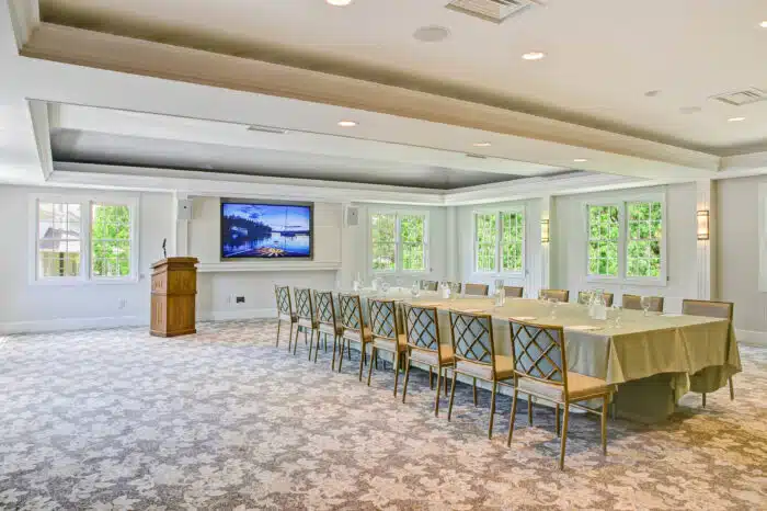 Meeting table set with podium for a group meeting in the Club Room