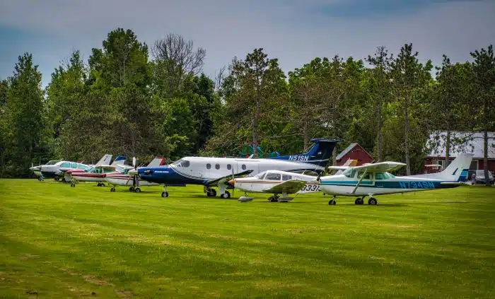 Several air planes lined up on the air strip
