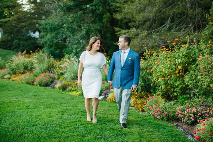 A bride and groom walking together on the Sunshine Lawn