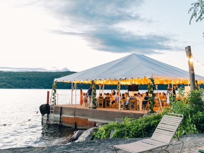 Group sitting enjoying dinner on the North Dock at Basin Harbor