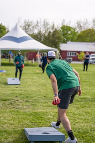 Two people playing cornhole at Basin Harbor. Team building at Basin Harbor