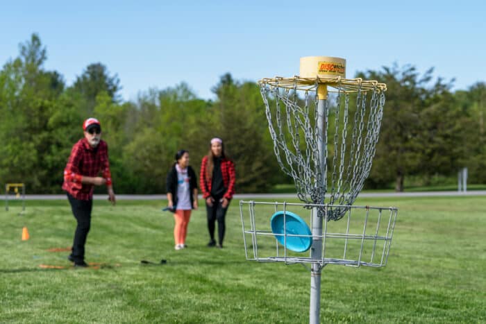 A group playing frisbee golf. Team building at Basin Harbor