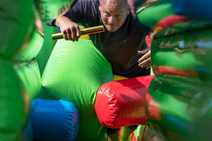 Player diving into an inflatable obstacle course.