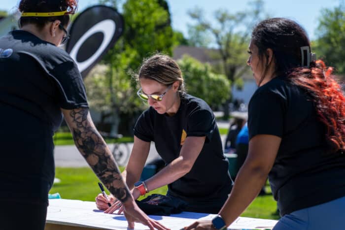 Cardboard challenge for team building. Group figure out their challenge.