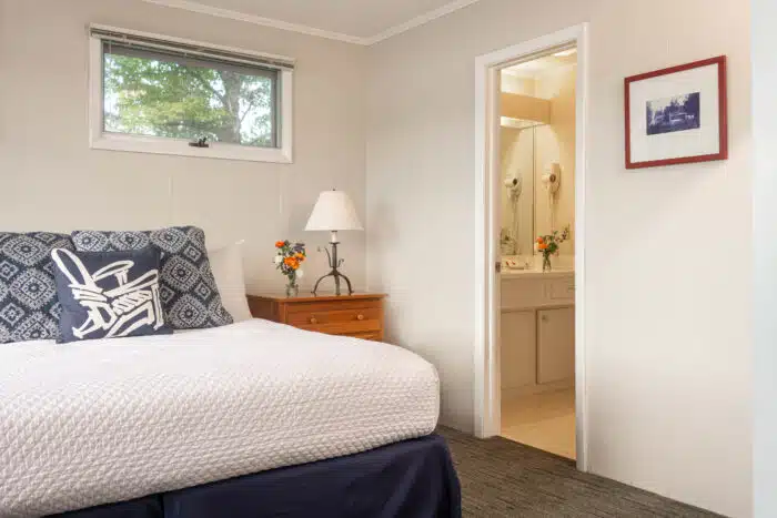 A bedroom with a queen bed in one of the accommodations