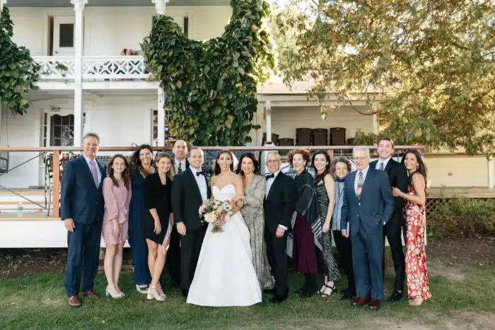 Bride and groom with family in front of the Lodge