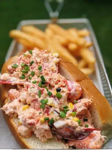 A lobster roll with a side of fries