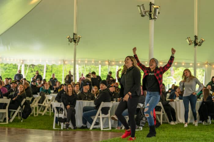 Three women cheer as they're announced winners of their team building challenge.