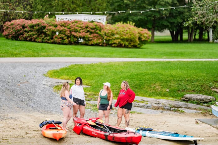 A group of people getting ready to go out kayaking