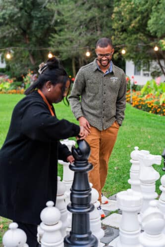 A couple playing giant chess.