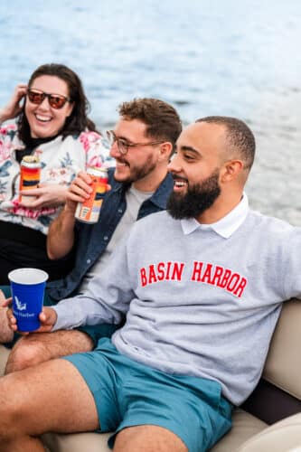 A group of friends laughing while sitting on a boat