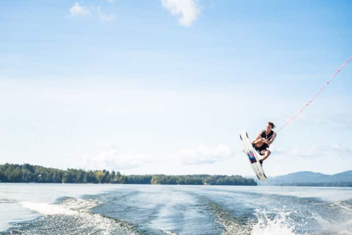 A man jumping while wave boarding on the lake