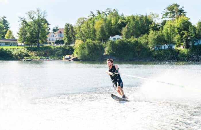 A man wave boarding on the lake