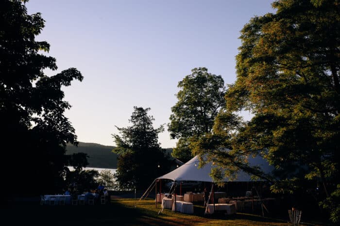 A wedding tent set up on a lawn.