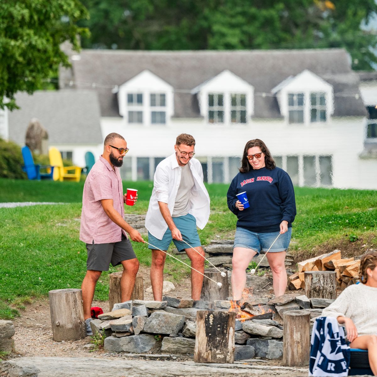 A group of friends roasting marshmallows over a fire.