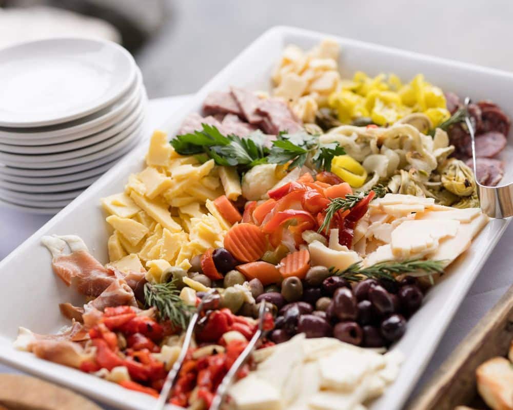 A platter of different vegetables, meats, and cheeses.