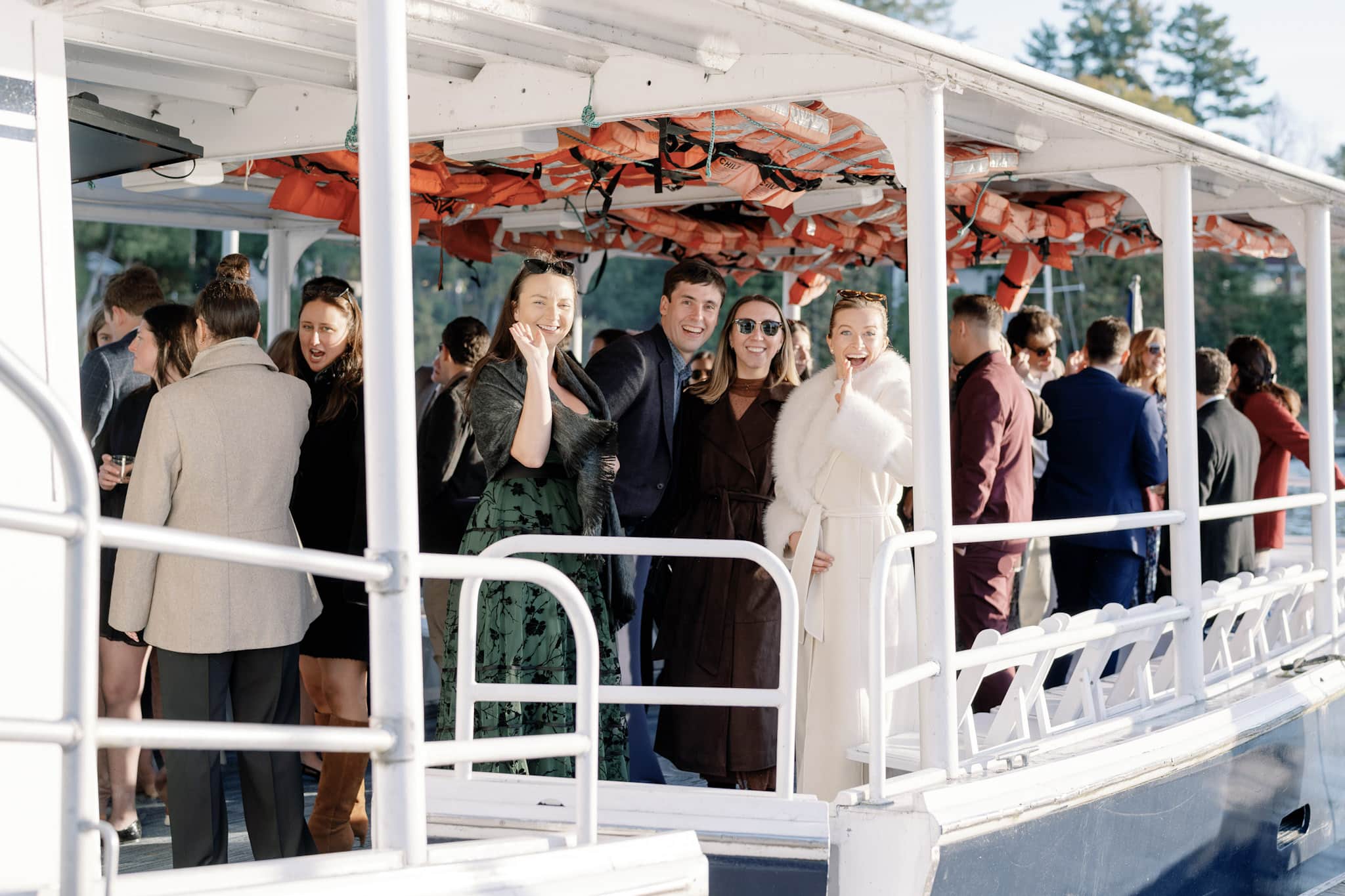 A group celebrating an event out of a luxury boat in the middle of a lake