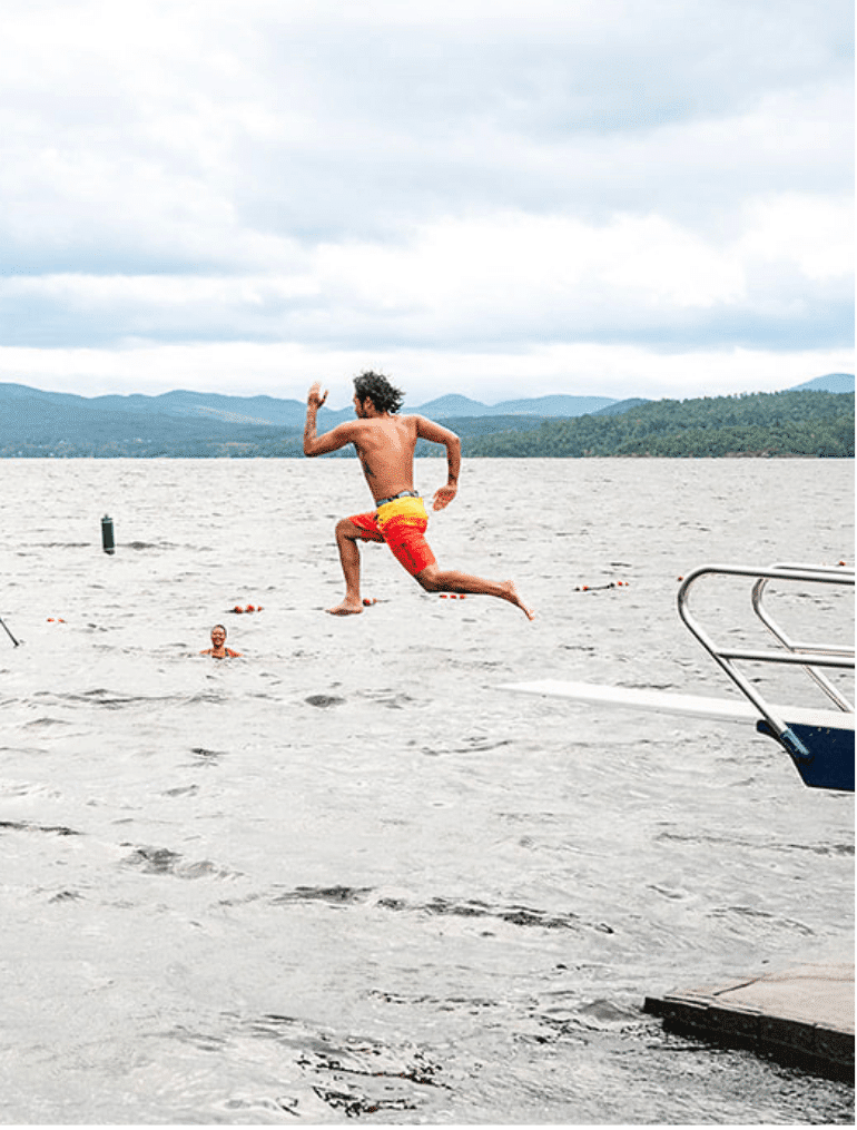 A person jumping into a lake